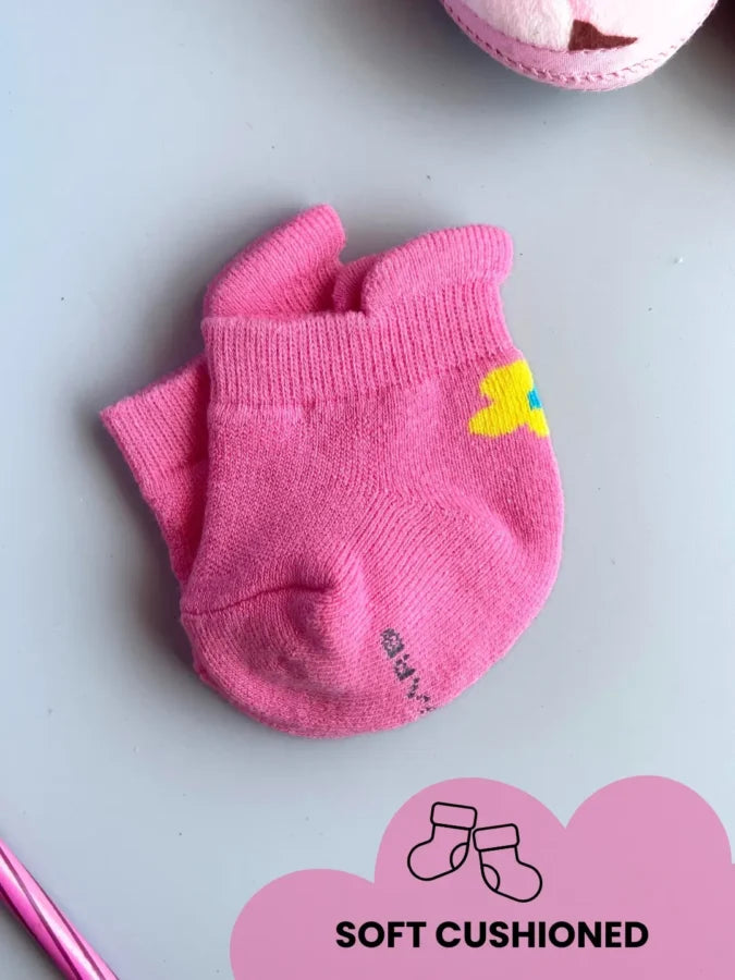 Air Garb brand baby combo socks for infants 0-1 years; a 6-pair collection arranged in a circle featuring three pairs with side flower designs (pink, yellow, mint) and three pairs with kitten face cuffs (purple, lime green, blue).