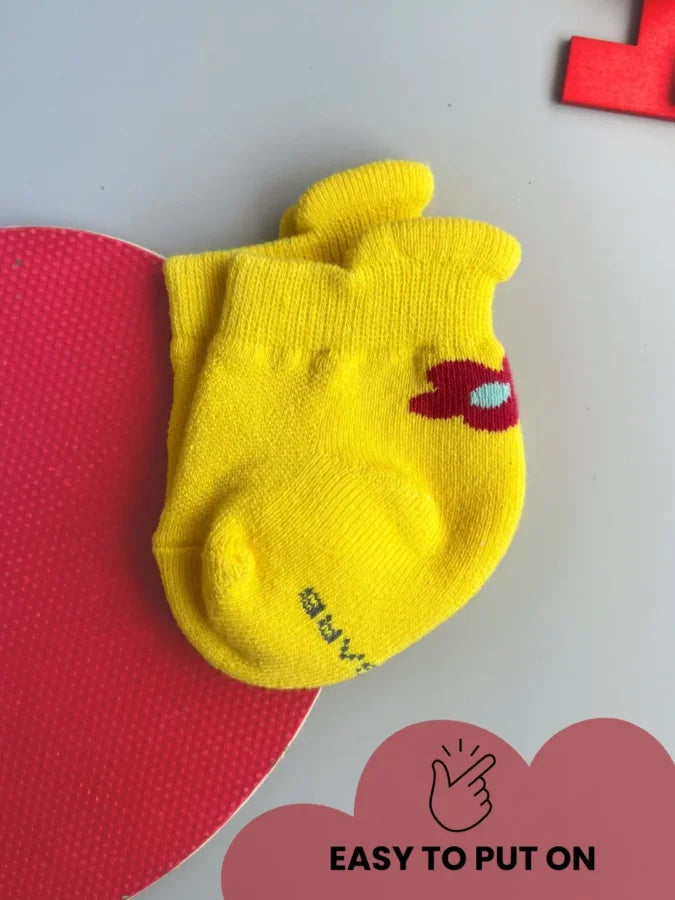 Air Garb brand baby combo socks for infants 0-1 years; a 6-pair collection arranged in a circle featuring three pairs with side flower designs (pink, yellow, mint) and three pairs with kitten face cuffs (purple, lime green, blue).