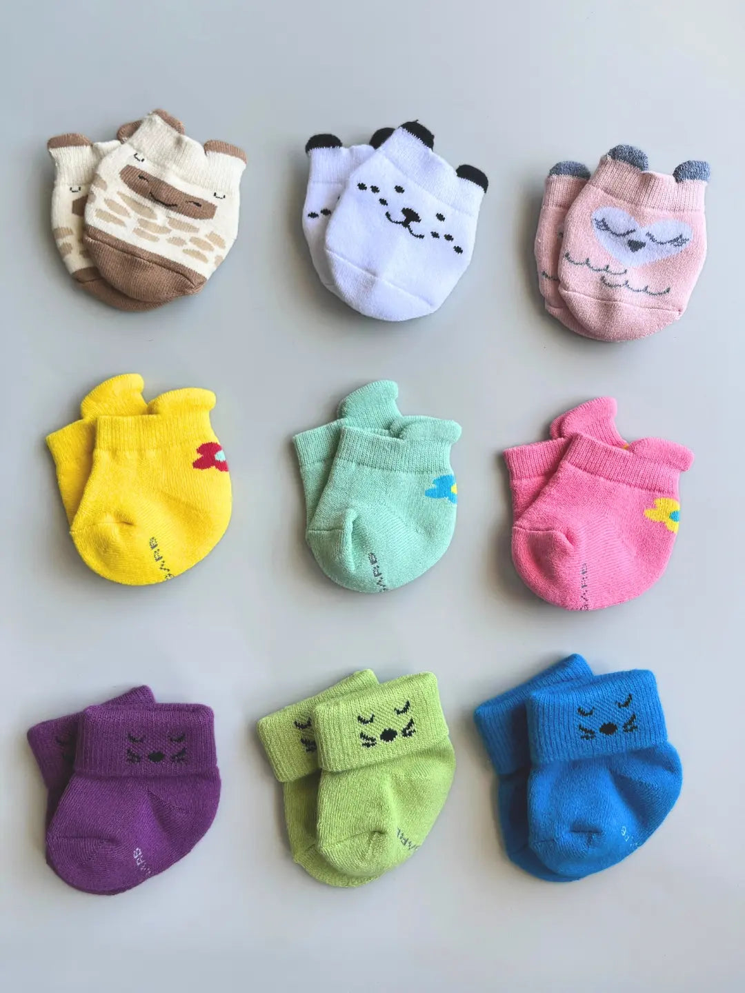 Air Garb baby combo socks set featuring 9 pairs of soft cotton infant socks for 0-1 year olds in assorted bright colors and cute animal patterns.